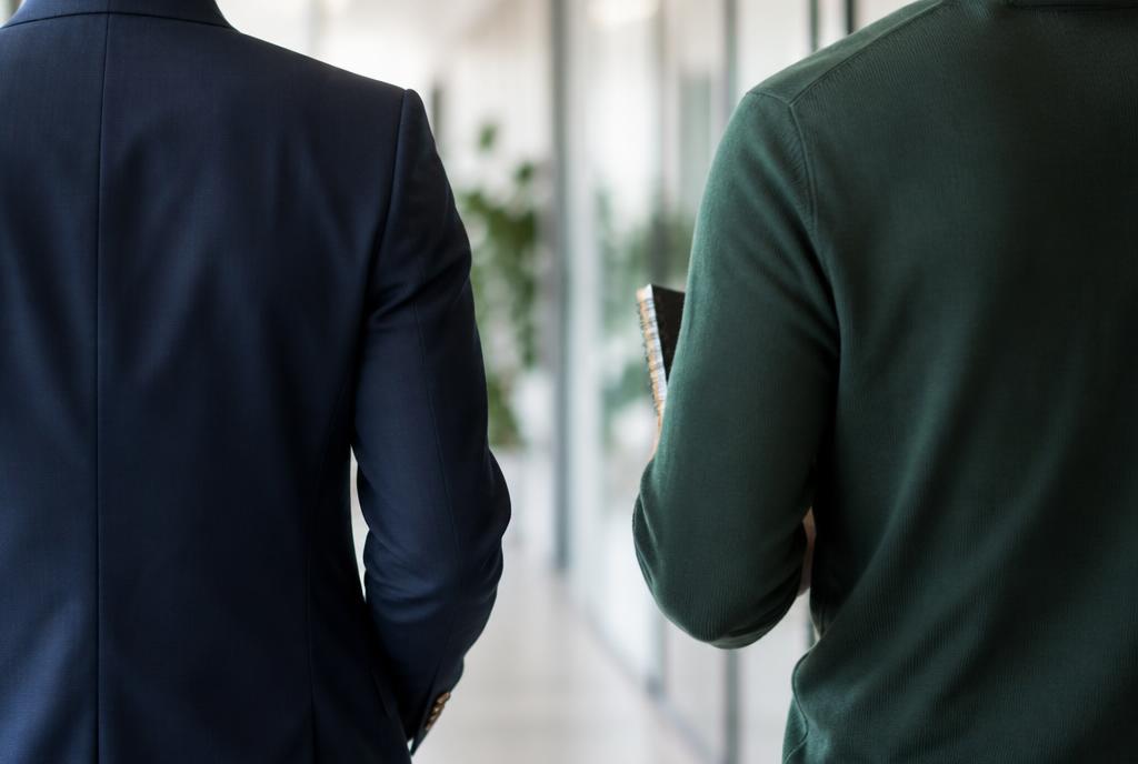 Colleagues talking while walking through the office